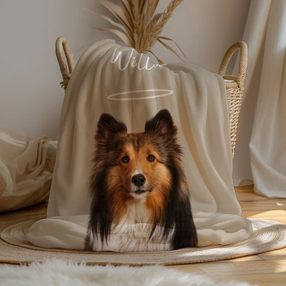 Personalized pet memorial blanket featuring a Sheltie portrait with a soft halo design, displayed in a warm home setting.